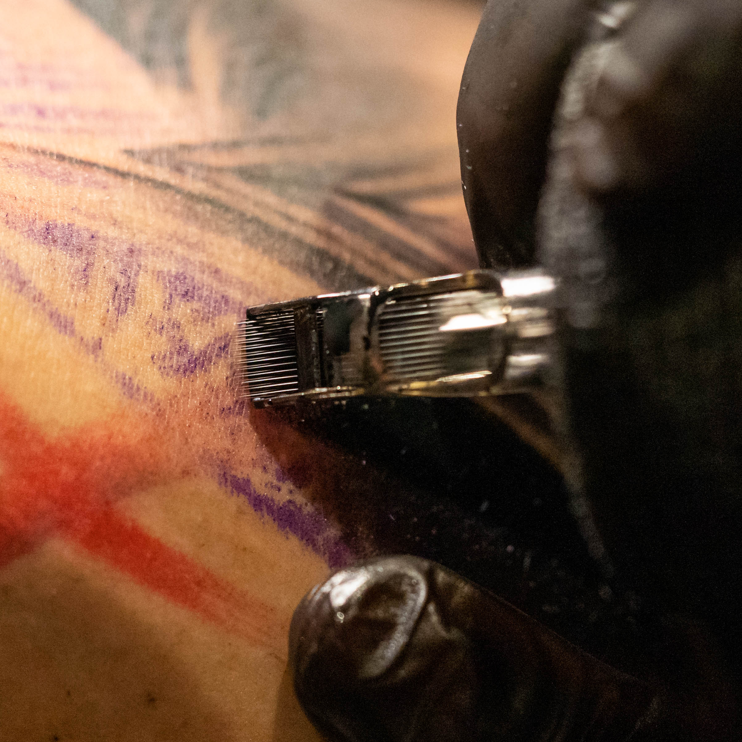 Close-up of a mag needle shading over purple stencil