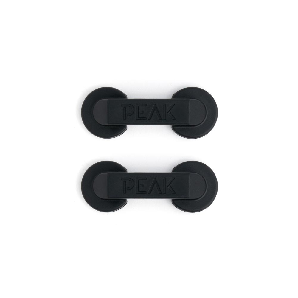 Aerial view of two black cord managers on white background