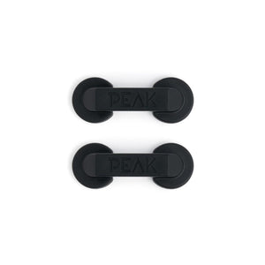 Aerial view of two black cord managers on white background