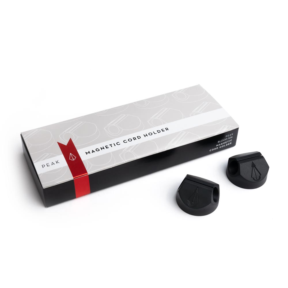 Box of Magnetic Cord Holders with two holders out of box on white background, full size