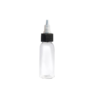 Clear plastic empty tattoo ink bottle with a black twist-off cap on a white background.