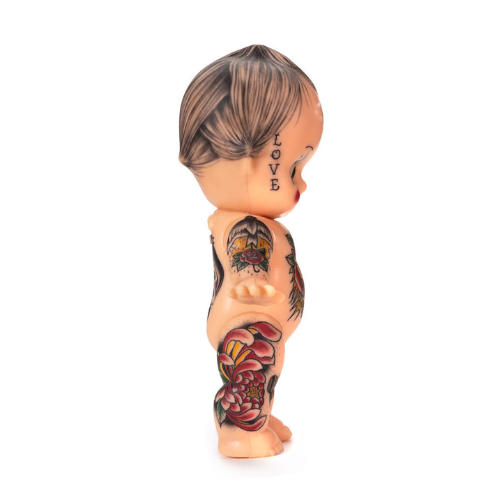 Light-toned tattooable cutie doll with American-traditional tattooes side-facing with a white background.