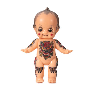 Light-toned tattooable cutie doll with American-traditional tattooes with a white background.