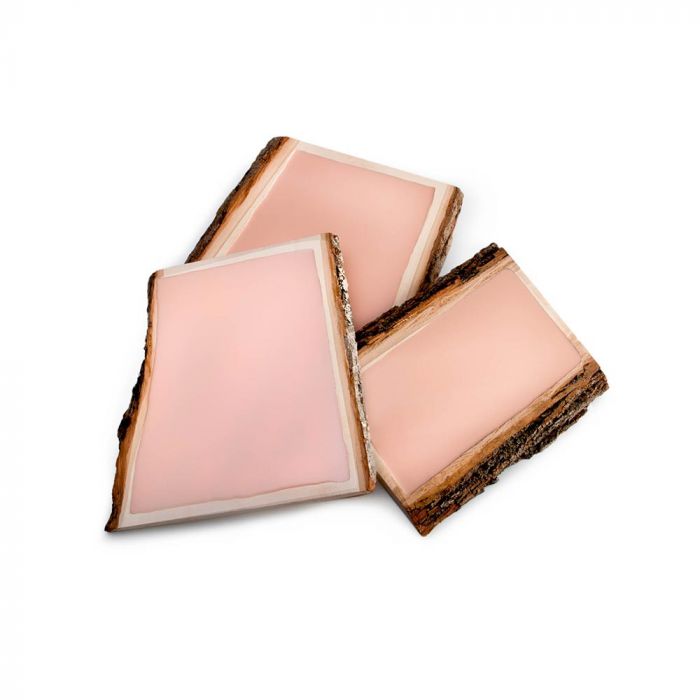 Three light-skin-toned tattooable canvas imbedded in a rectangle slab of wood.