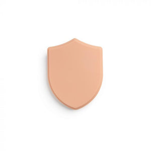 Light-toned tattooable flesh in the shape of a shield on a white background.
