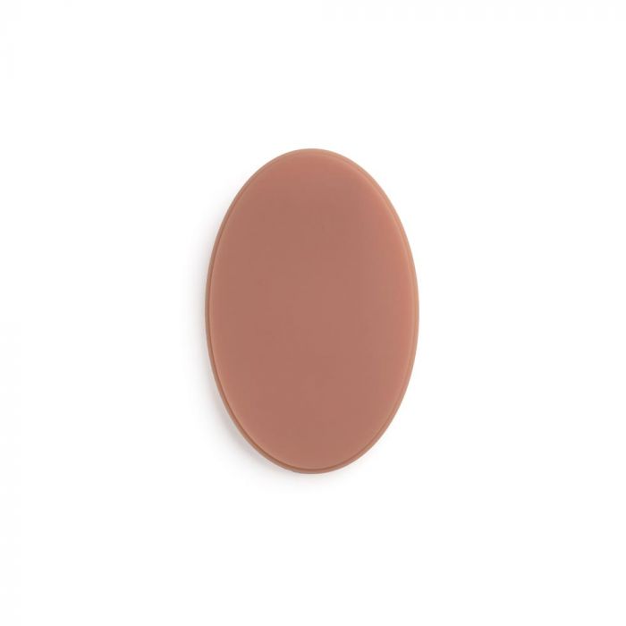 Medium-toned oval of tattooable flesh on a white background.