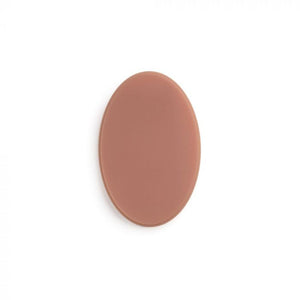 Medium-toned oval of tattooable flesh on a white background.