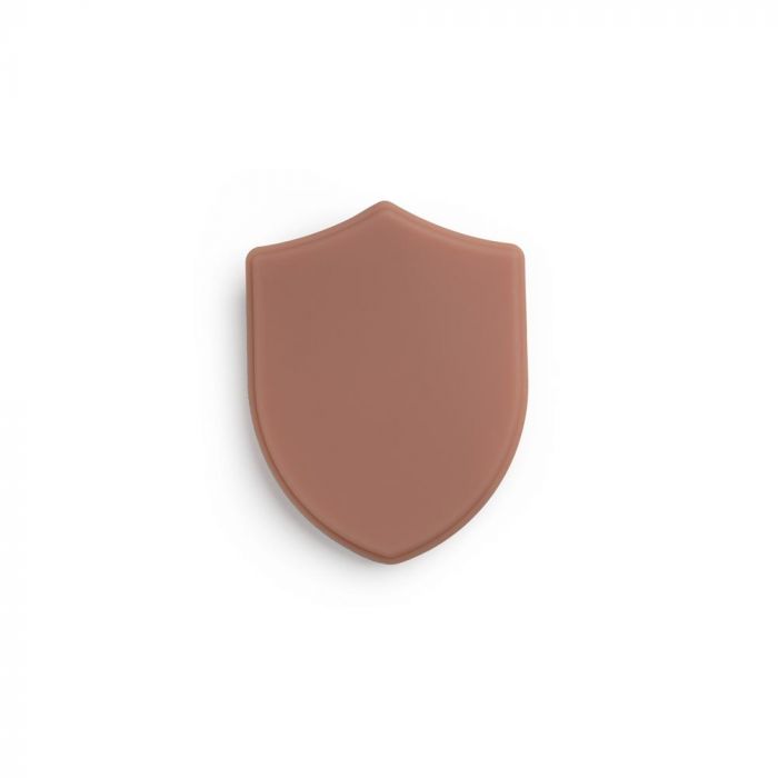 Medium-toned tattooable flesh in the shape of a shield on a white background.