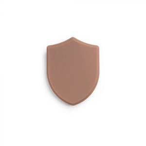 Medium-dark-toned tattooable flesh in the shape of a shield on a white background.