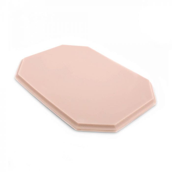 Pink-toned tattooable flesh in the shape of an octagonal plaque on a white background.