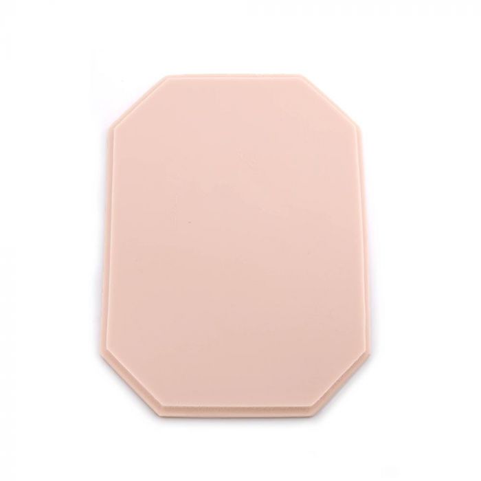 Pink-toned tattooable flesh in the shape of an octagonal plaque on a white background.