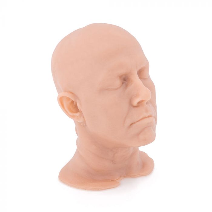 Light-toned tattooable flesh in the shape of a man's head and neck on a white background. The head is diagonal-facing.