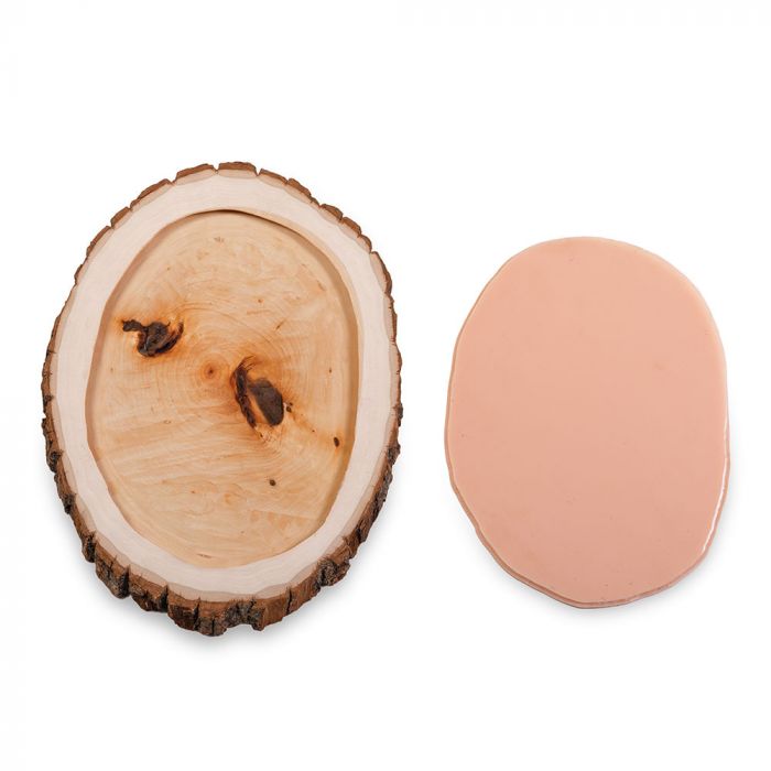 Tattooable flesh imbedded in a frame that looks like a wooden slab from the branch of a tree. This product is posed in front of a white background.
