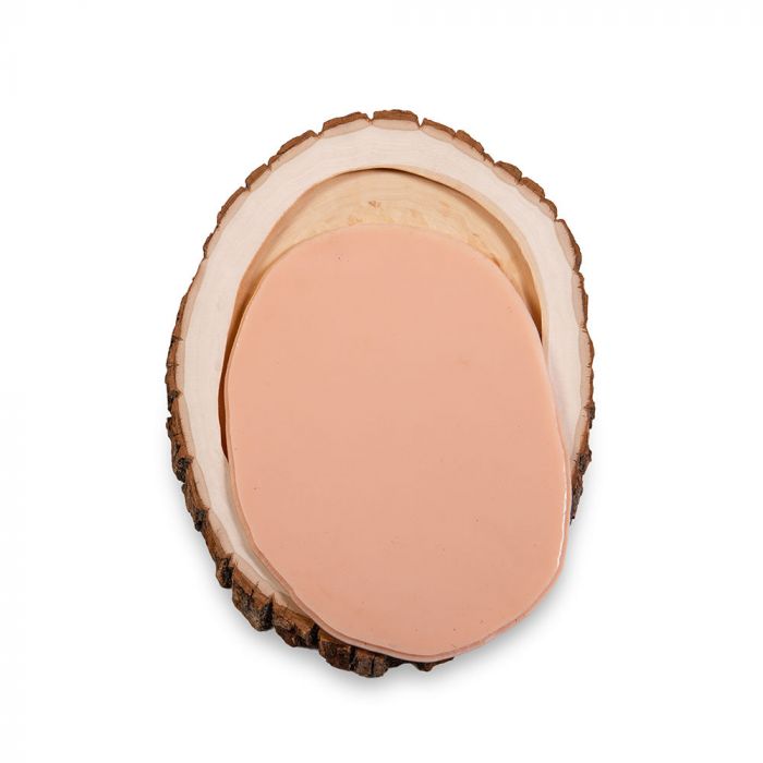 Tattooable flesh imbedded in a frame that looks like a wooden slab from the branch of a tree. This product is posed in front of a white background.