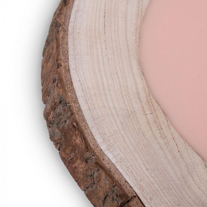 Close-up of tattooable flesh imbedded in a frame that looks like a wooden slab from the branch of a tree. This product is posed in front of a white background.