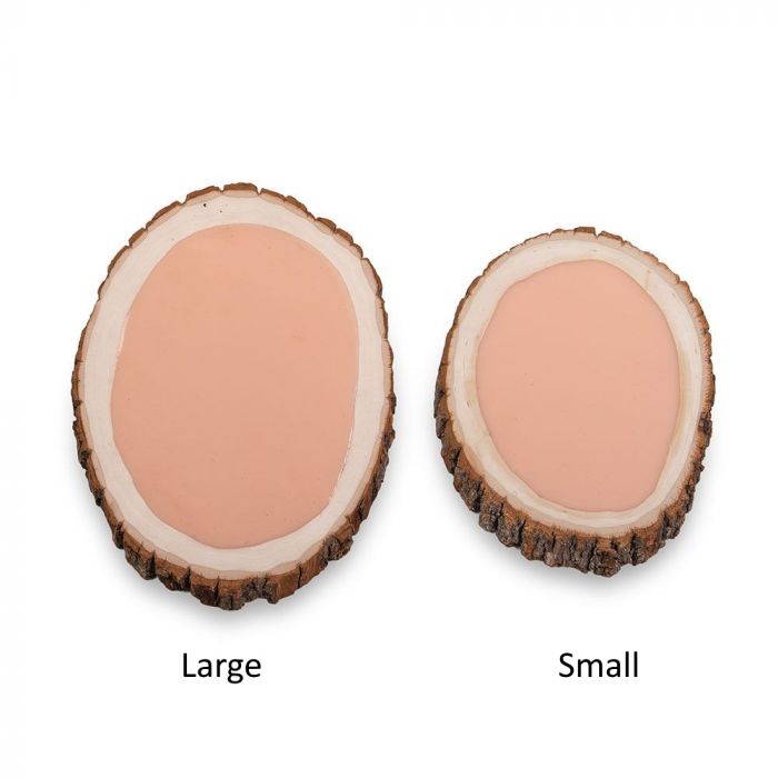 Tattooable flesh imbedded in a frame that looks like a wooden slab from the branch of a tree. This product is posed in front of a white background.